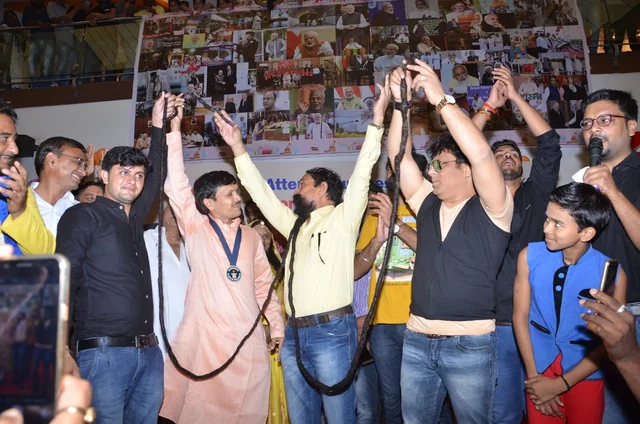 Visitors with their hands raised at the photograph exhibition